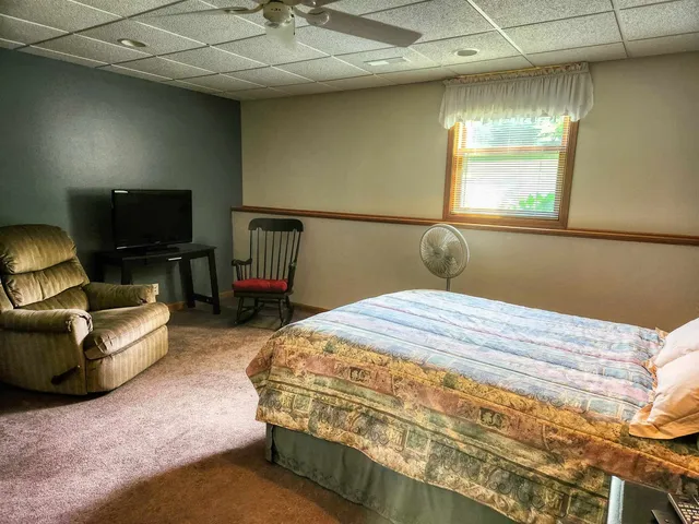 a bedroom with a bed and window