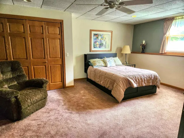 a bedroom with a bed couch and window