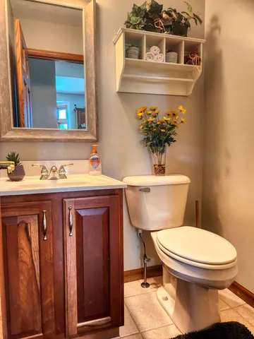 a bathroom with a toilet a sink and mirror