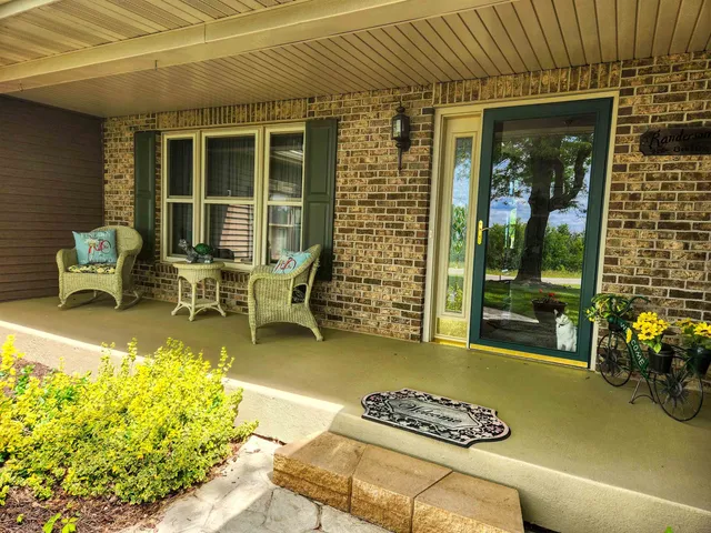 a balcony with furniture and a potted plant
