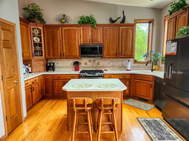 a kitchen with a sink a counter top space and cabinets