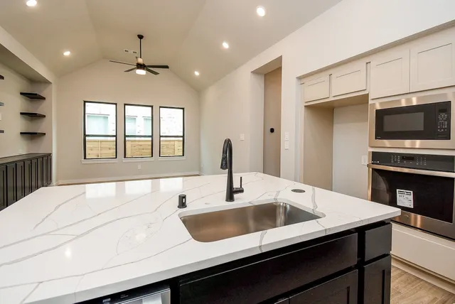 a kitchen with a sink and a refrigerator