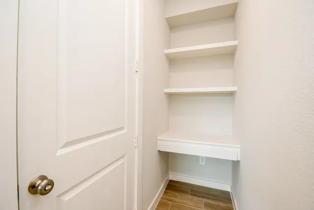 a large room with kitchen island a sink stainless steel appliances and cabinets