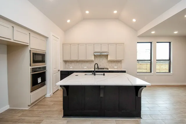 a kitchen with a sink and cabinets