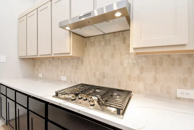 a close up of a stove top oven sitting inside of a kitchen
