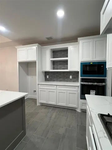 a kitchen with a cabinets and white appliances