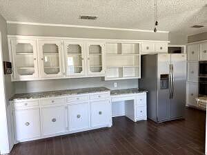 3206 77th Street Lubbock, TX 79423 - Photo 13 of 35 a kitchen with stainless steel appliances granite countertop a refrigerator and a sink