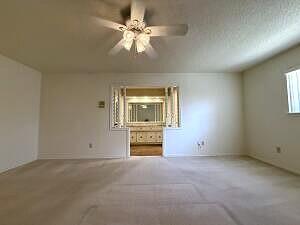 3206 77th Street Lubbock, TX 79423 - Photo 14 of 35 an empty room with chandelier fan and windows