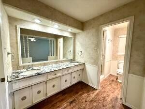 3206 77th Street Lubbock, TX 79423 - Photo 17 of 35 a bathroom with a granite countertop sink and a mirror