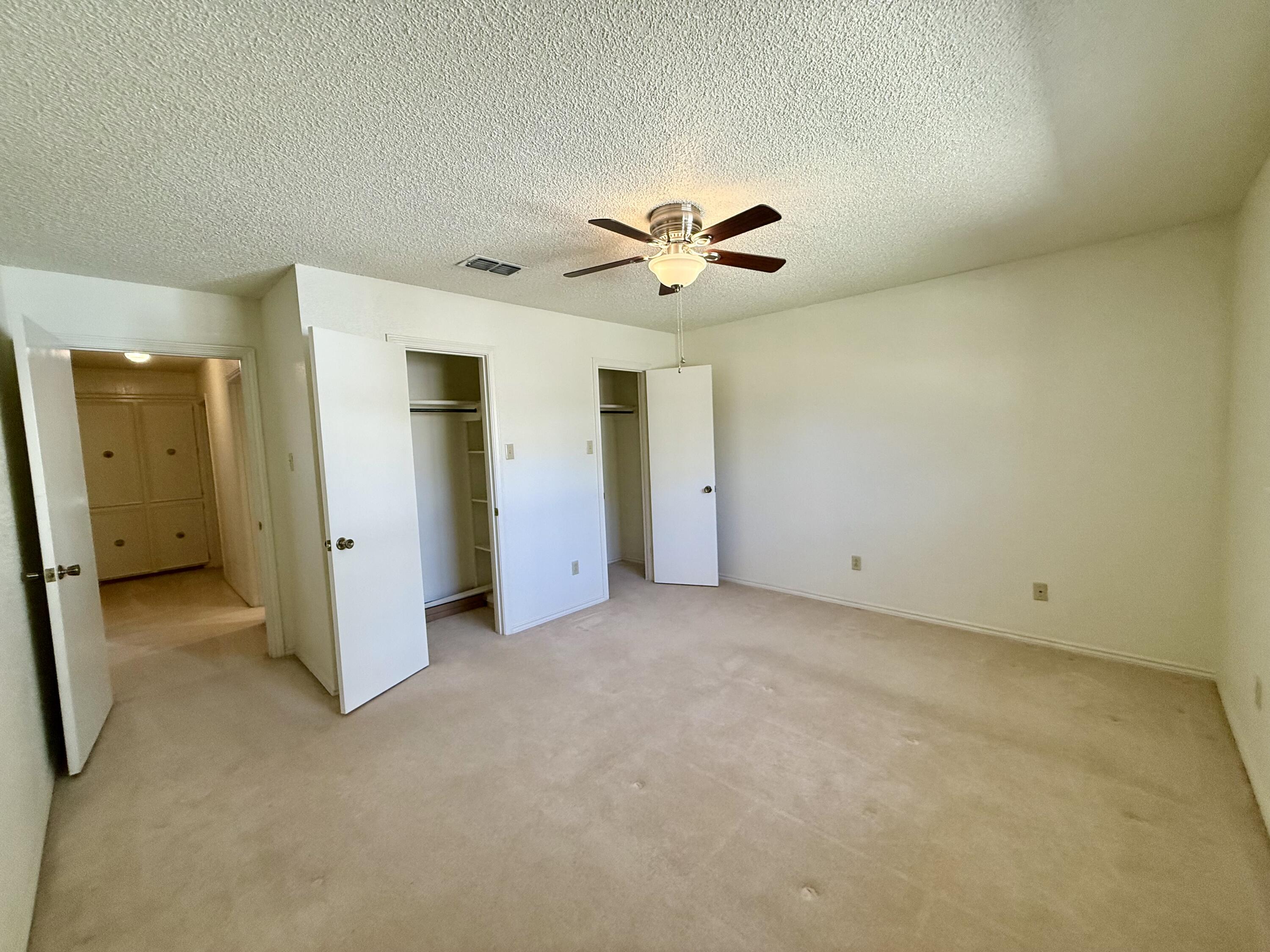 3206 77th Street Lubbock, TX 79423 - Photo 20 of 35 an empty room with a ceiling fan and a window