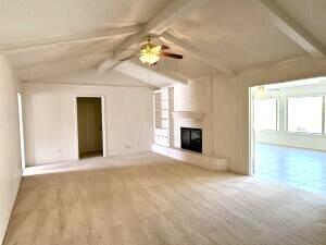 3206 77th Street Lubbock, TX 79423 - Photo 2 of 35 a view of an empty room with a fireplace and a window
