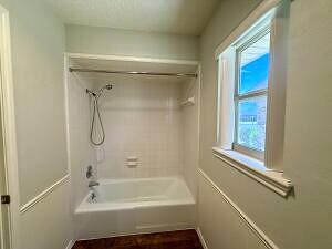 3206 77th Street Lubbock, TX 79423 - Photo 24 of 35 a bathroom with a tub and a shower