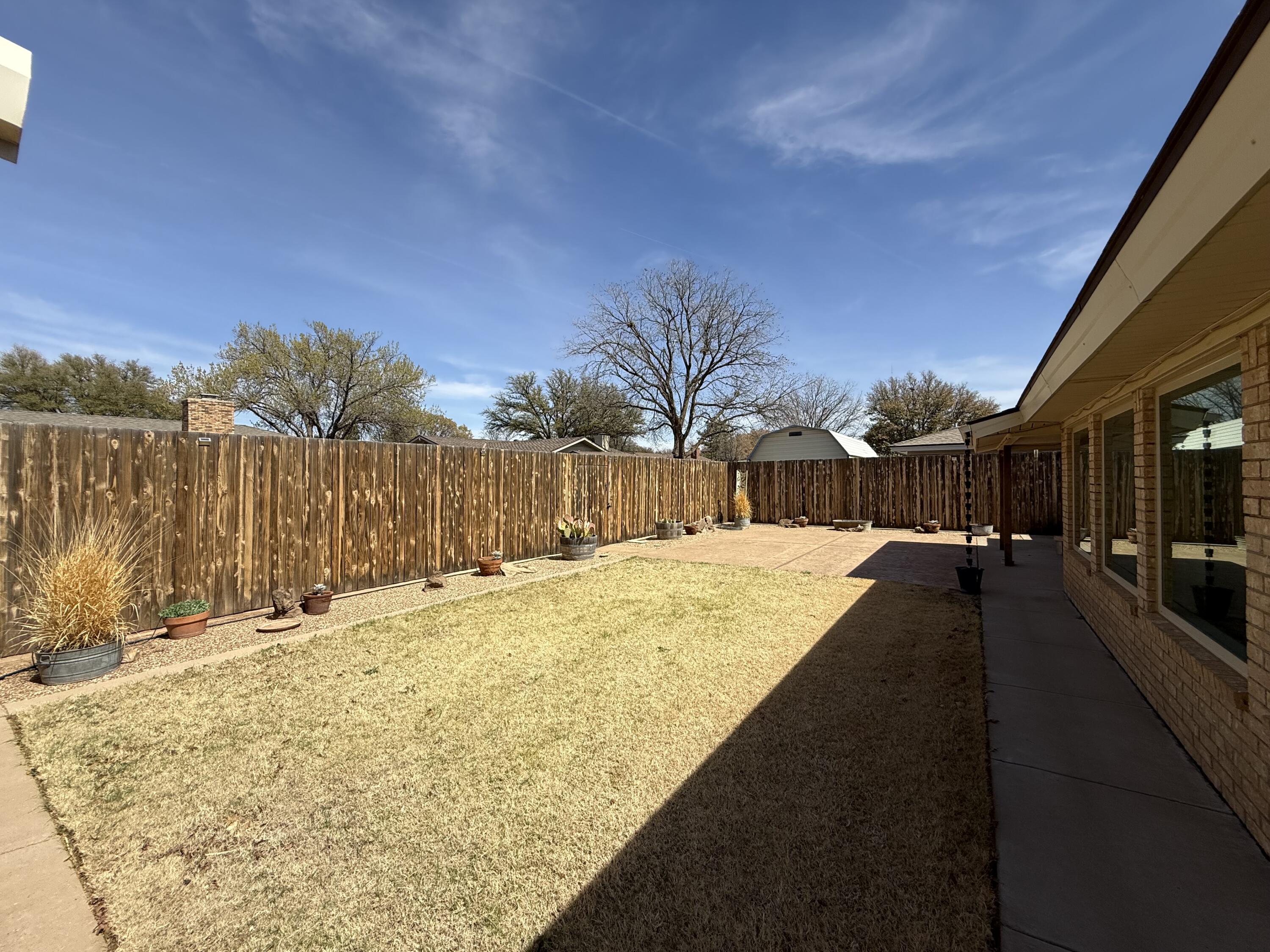 3206 77th Street Lubbock, TX 79423 - Photo 28 of 35 a swimming pool with wooden fence