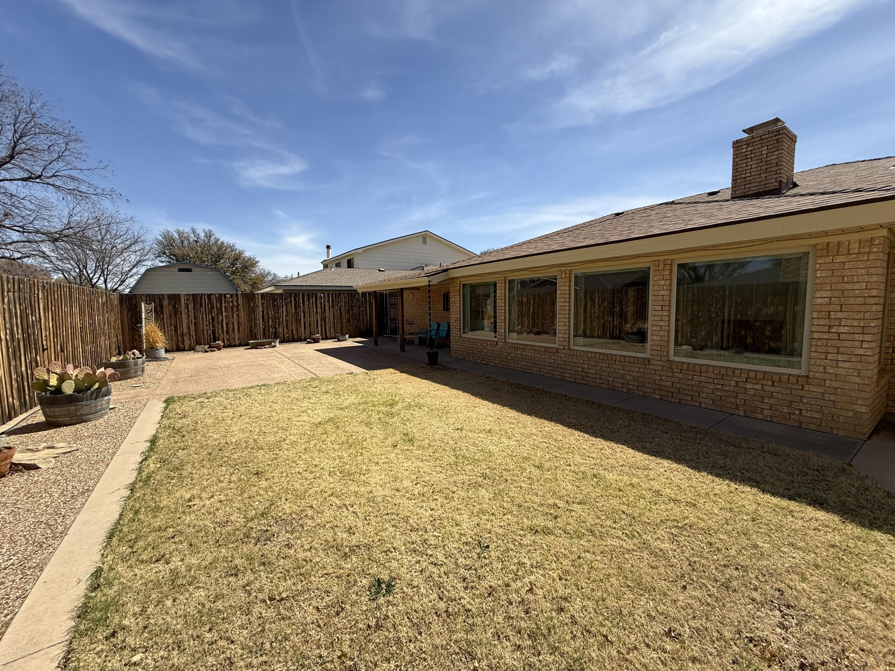3206 77th Street Lubbock, TX 79423 - Photo 29 of 35 a view of a house with a yard