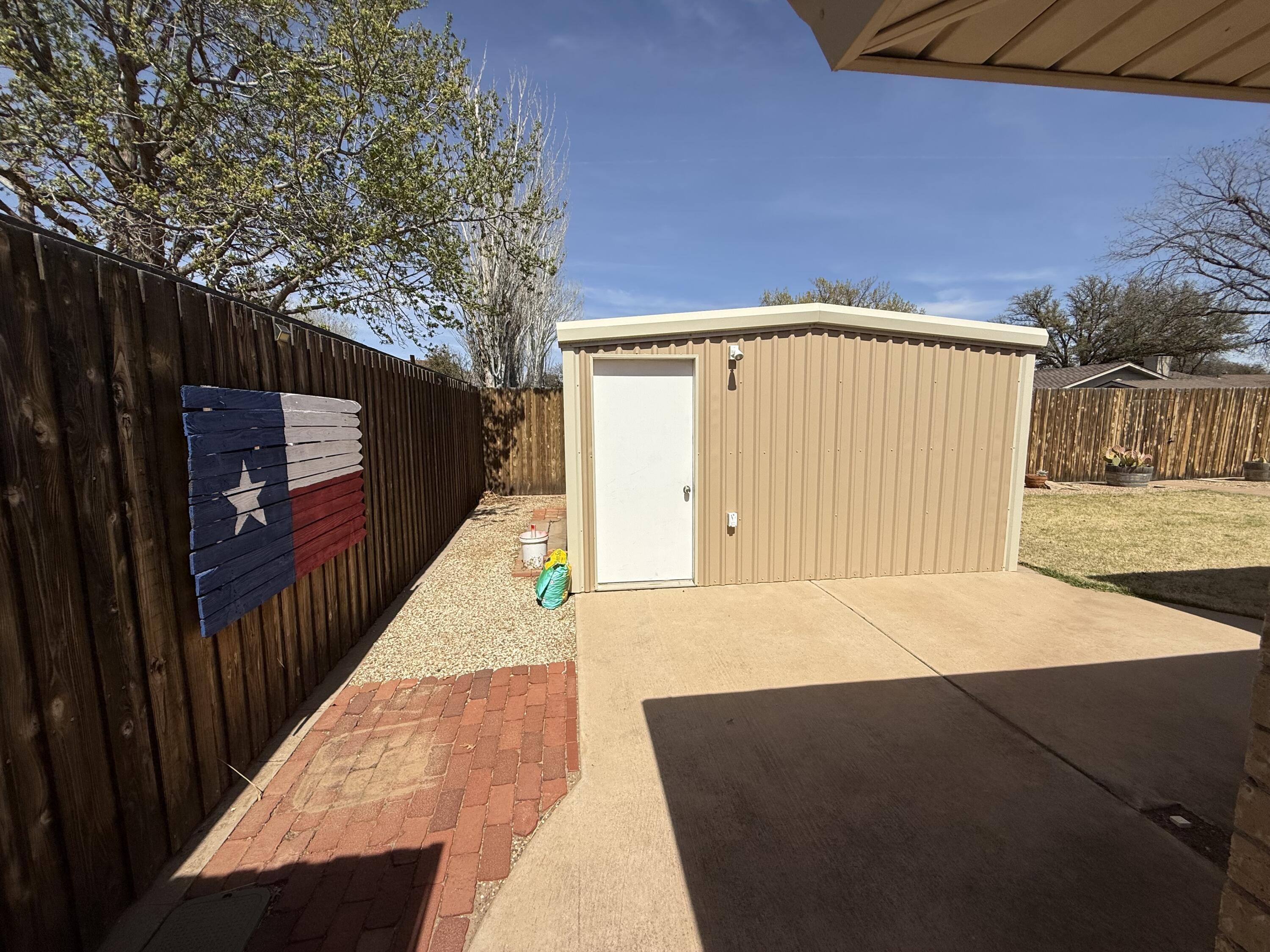 3206 77th Street Lubbock, TX 79423 - Photo 32 of 35 a view of backyard with wooden fence and large trees