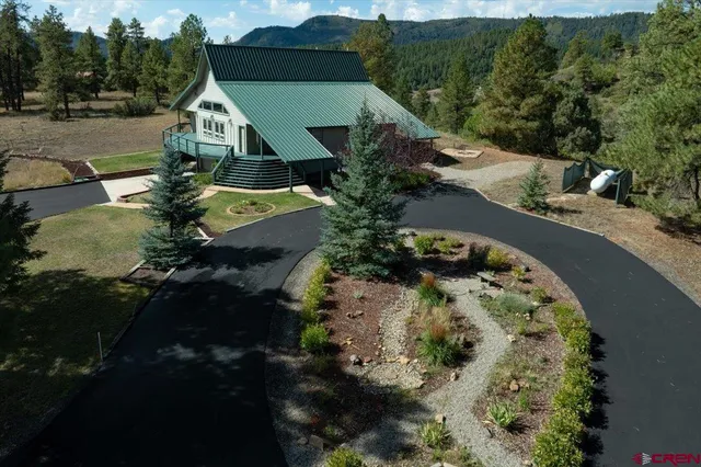 an aerial view of a house with a yard pool patio and lake view