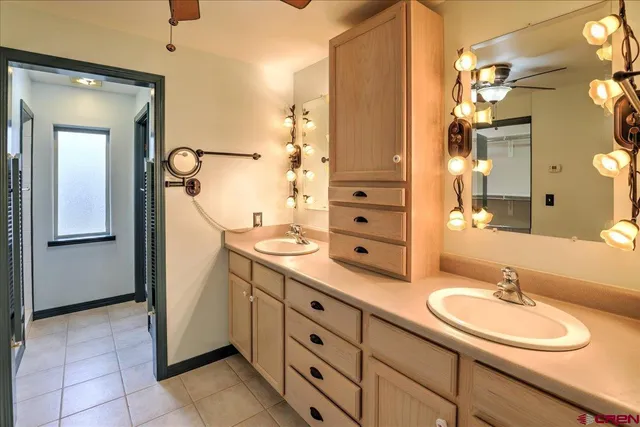 a bathroom with a double vanity sink mirror and