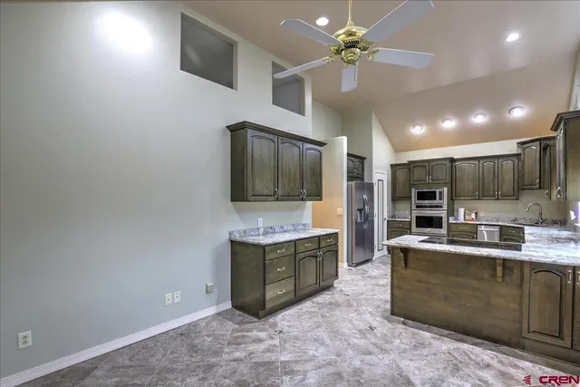 a kitchen with stainless steel appliances granite countertop a sink and cabinets