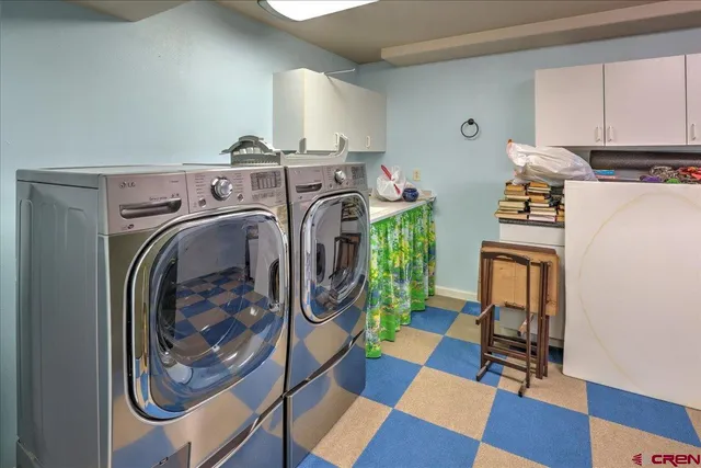 a utility room with sink dryer and washer