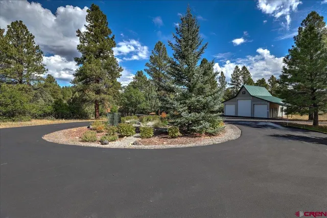 a view of a house with a yard and garage