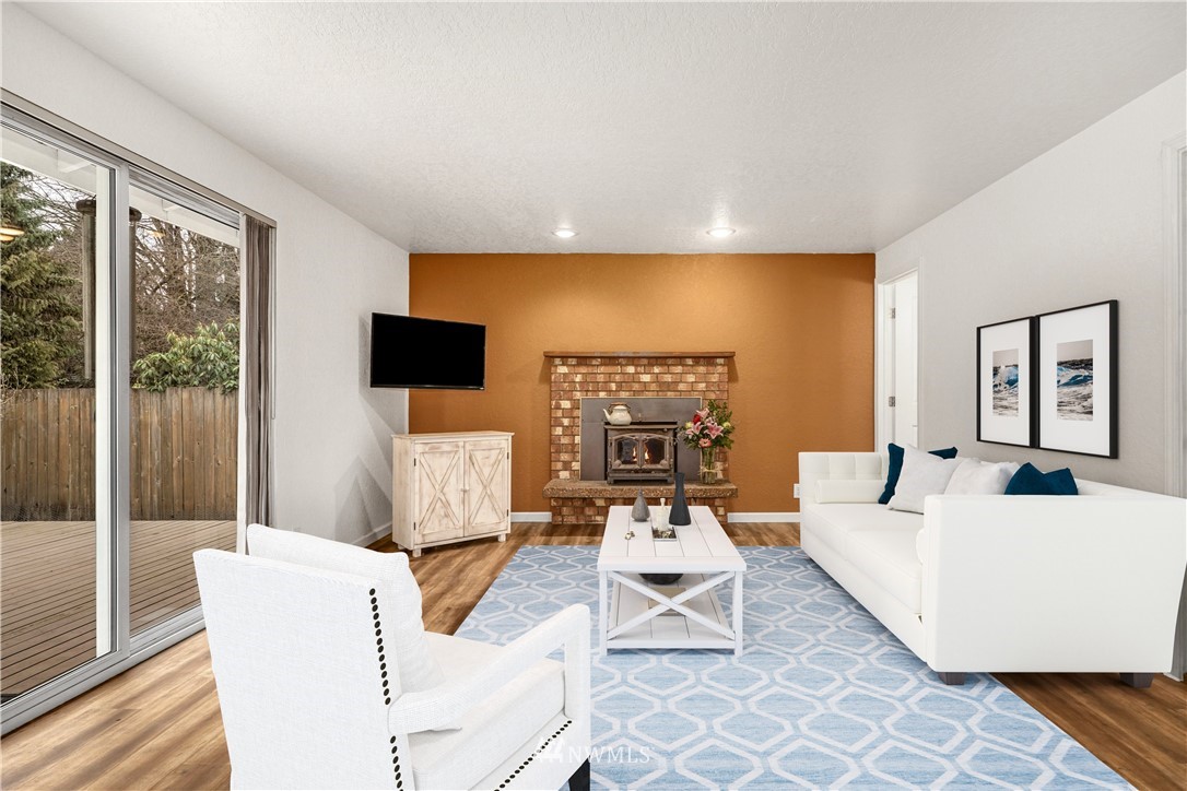 17409 29th Drive Southeast Bothell, WA 98012 - Photo 13 of 37 a living room with furniture a flat screen tv and a floor to ceiling window