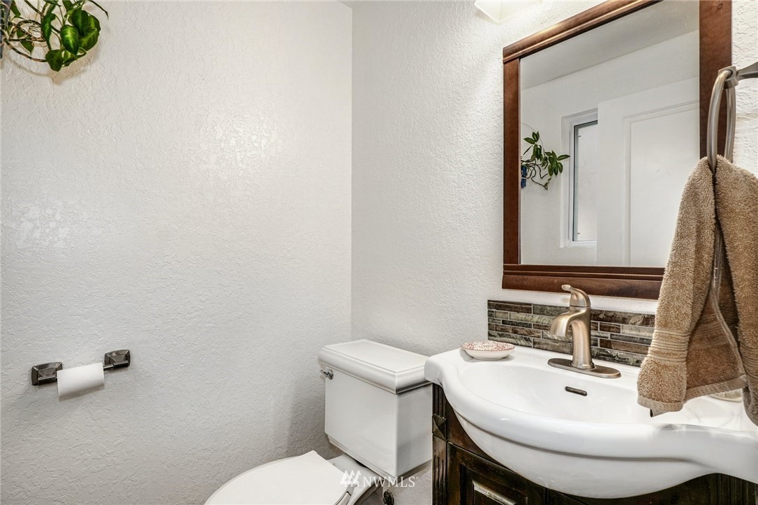 17409 29th Drive Southeast Bothell, WA 98012 - Photo 15 of 37 a bathroom with a sink a toilet and mirror