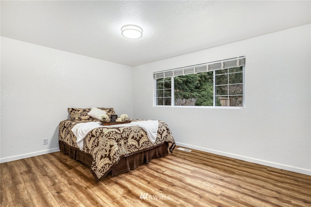 17409 29th Drive Southeast Bothell, WA 98012 - Photo 16 of 37 a bed sitting in a bedroom next to a window