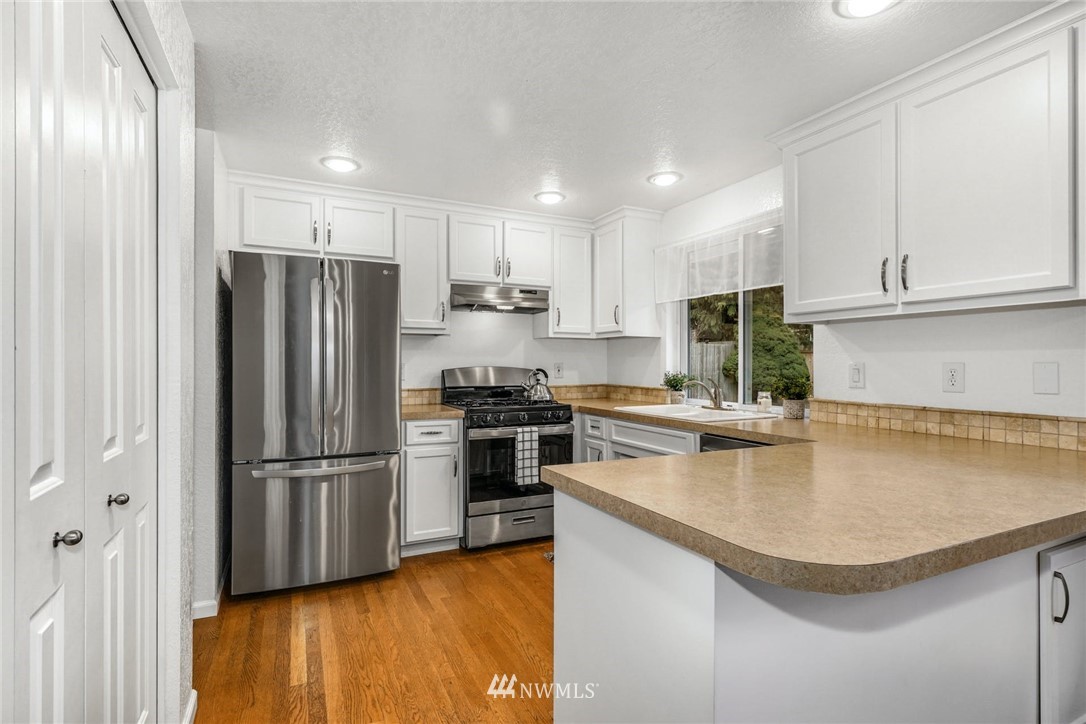 17409 29th Drive Southeast Bothell, WA 98012 - Photo 9 of 37 a kitchen with stainless steel appliances granite countertop a refrigerator a sink and a stove