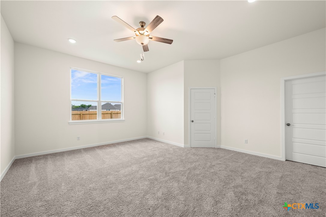 5102 Pollack Lane Belton, TX 76513 - Photo 20 of 30 an empty room with windows and chandelier fan