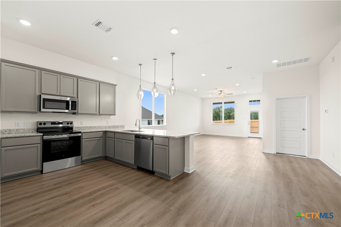 5102 Pollack Lane Belton, TX 76513 - Photo 22 of 30 a large kitchen with stainless steel appliances granite countertop a lot of counter space and wooden floors