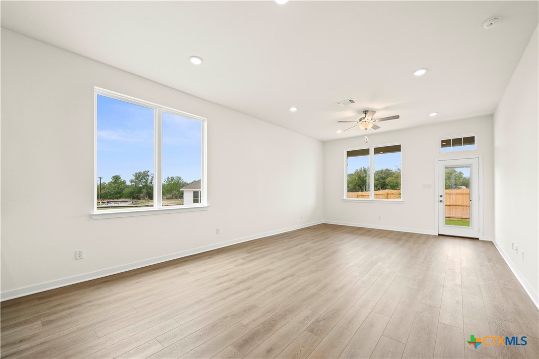 5102 Pollack Lane Belton, TX 76513 - Photo 25 of 30 an empty room with wooden floor and windows