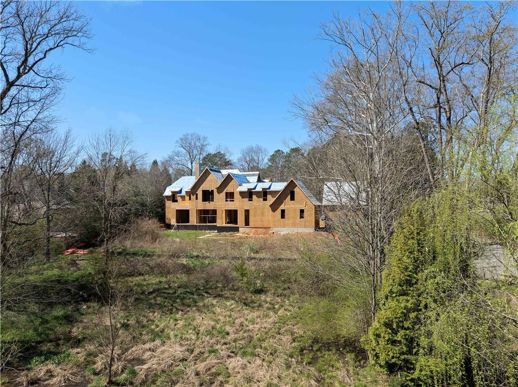 4957 Peachtree Dunwoody Road Sandy Springs, GA 30342 - Photo 6 of 54 a front view of a house with a yard