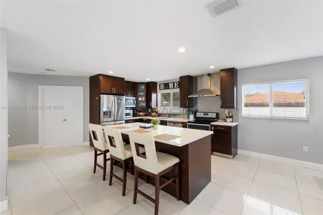 a large kitchen with a table and chairs in it