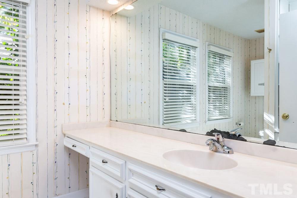 3000 Rue Sans Famille Raleigh, NC 27607 - Photo 14 of 23 a bathroom with a sink and a mirror