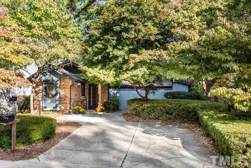 3000 Rue Sans Famille Raleigh, NC 27607 - Photo 4 of 23 a front view of a house with a yard and trees