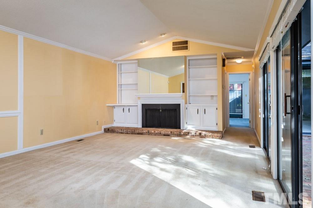 3000 Rue Sans Famille Raleigh, NC 27607 - Photo 8 of 23 a view of an empty room with a fireplace and a window