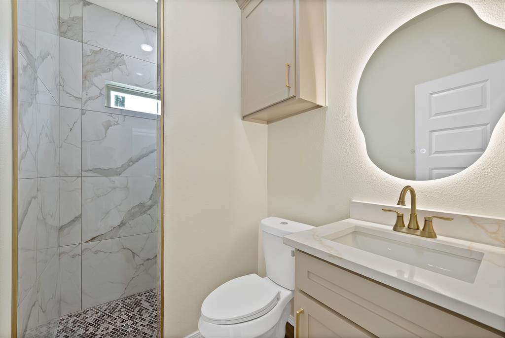 501 Harris Road Azle, TX 76020 - Photo 14 of 29 a bathroom with a sink a toilet and a mirror