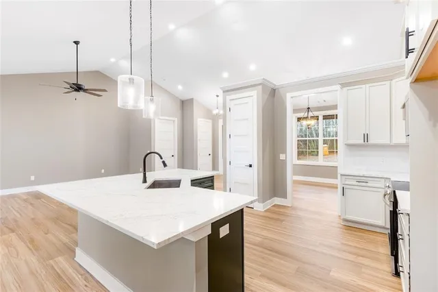 a kitchen with stainless steel appliances granite countertop a sink stove and refrigerator