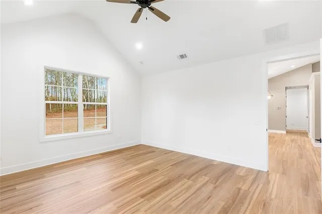 a view of a room with wooden floor and white walls