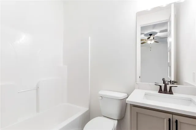 an empty room with a ceiling fan