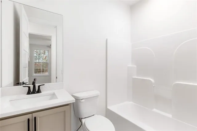 a view of a livingroom with a ceiling fan and wooden floor