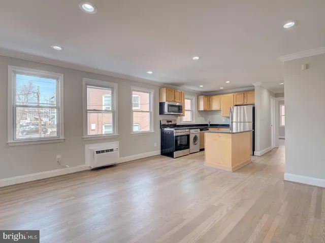a view of kitchen with wooden floor and windows