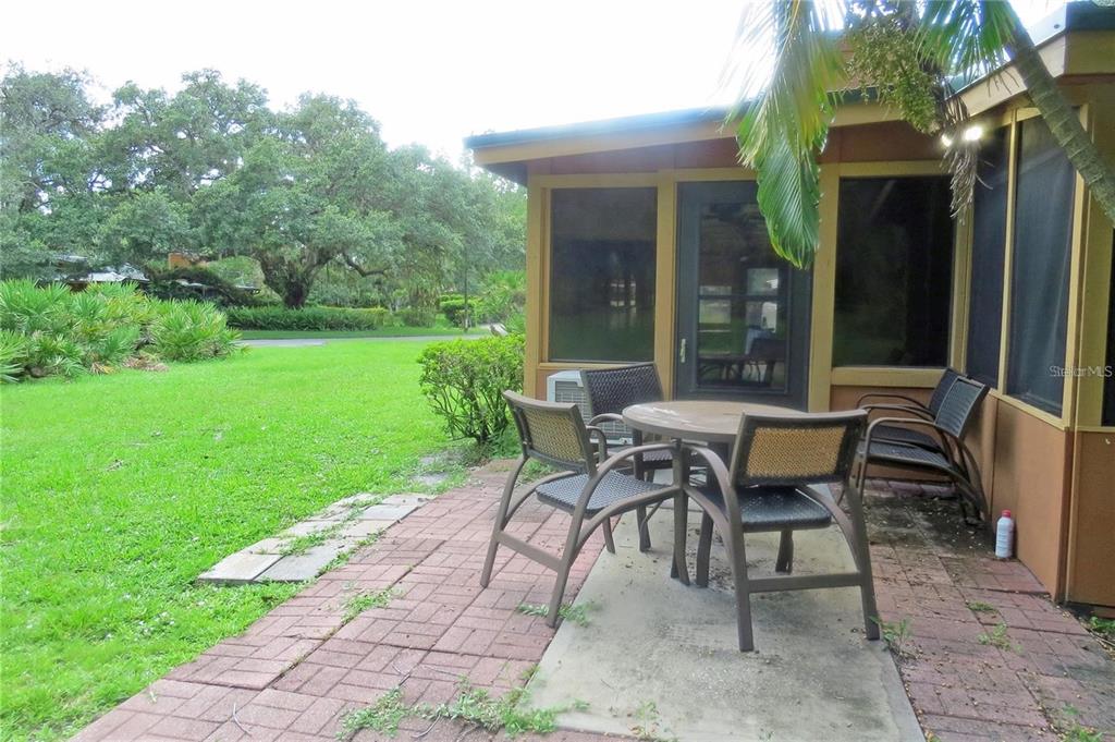 454 Cottage Circle, Unit 454 River Ranch, FL 33867 - Photo 27 of 27 a view of a house with backyard sitting area and garden