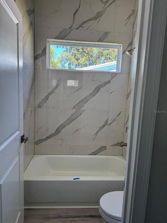 3862 Southwest 147th Street Ocala, FL 34473 - Photo 19 of 29 a bathroom with a toilet and a bath tub