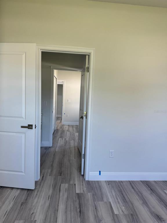 3862 Southwest 147th Street Ocala, FL 34473 - Photo 21 of 29 an empty room with wooden floor and closet