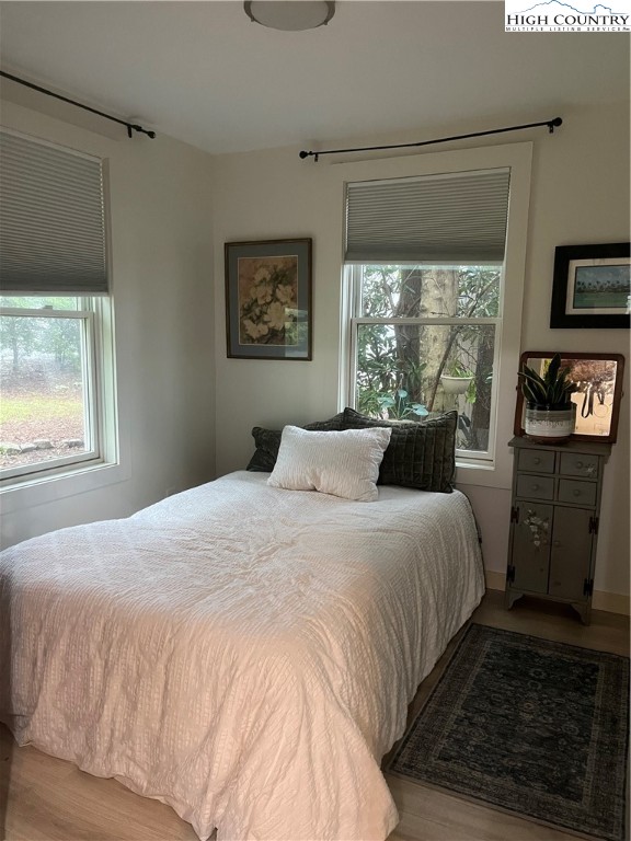 80 Pine Valley Road Newland, NC 28657 - Photo 8 of 12 a bedroom with a bed a dresser next to a window