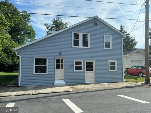 a front view of a house with trees