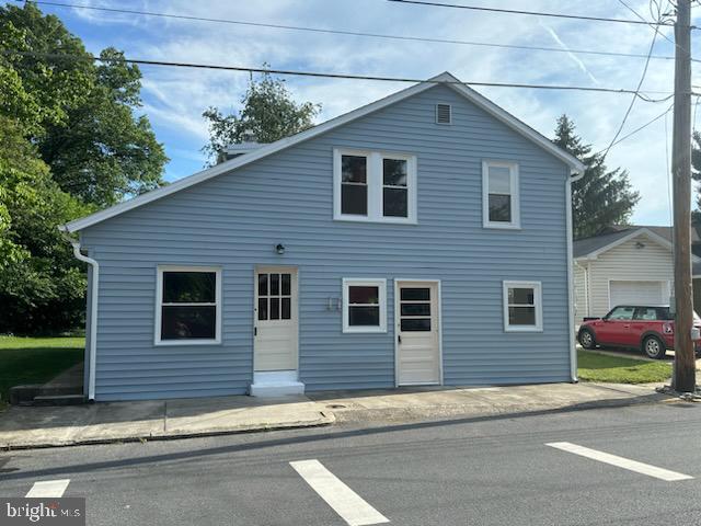 a front view of a house with trees