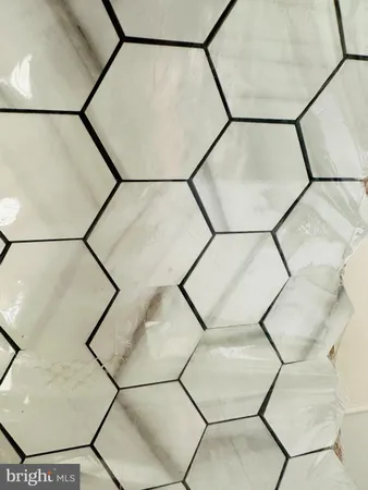a picture of a bathroom with a shower and a mirror