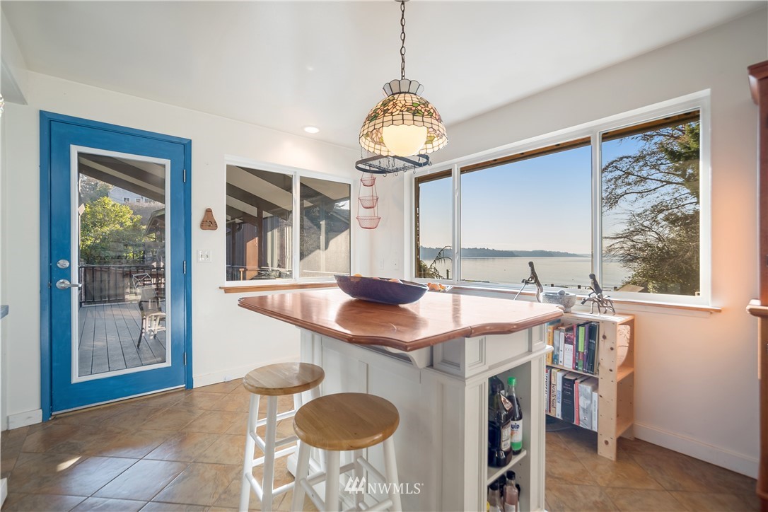 731 Woodmont Beach Road South Des Moines, WA 98198 - Photo 11 of 40 a kitchen with stainless steel appliances granite countertop a sink a stove and a dining table
